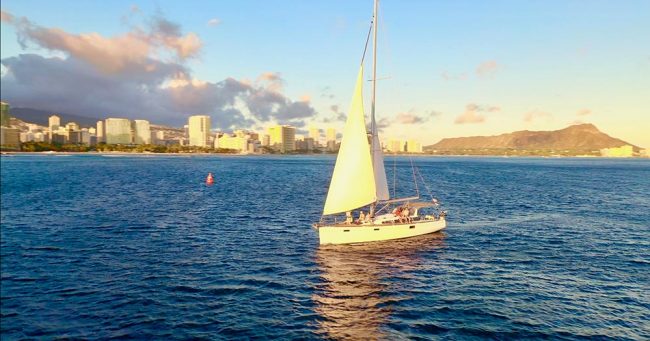 A sailboat is sailing in the ocean.