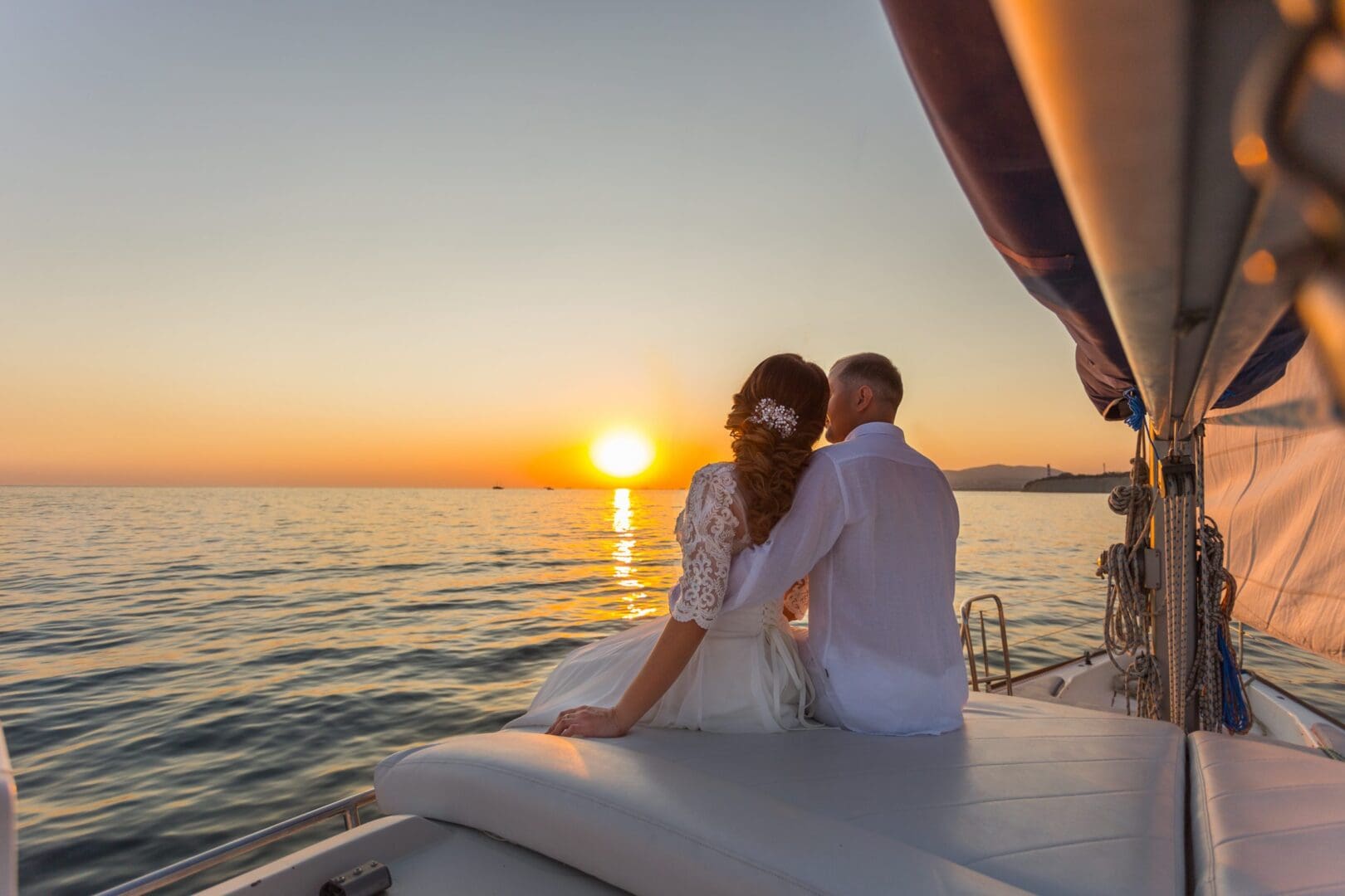 A man and woman sitting on the back of a boat.