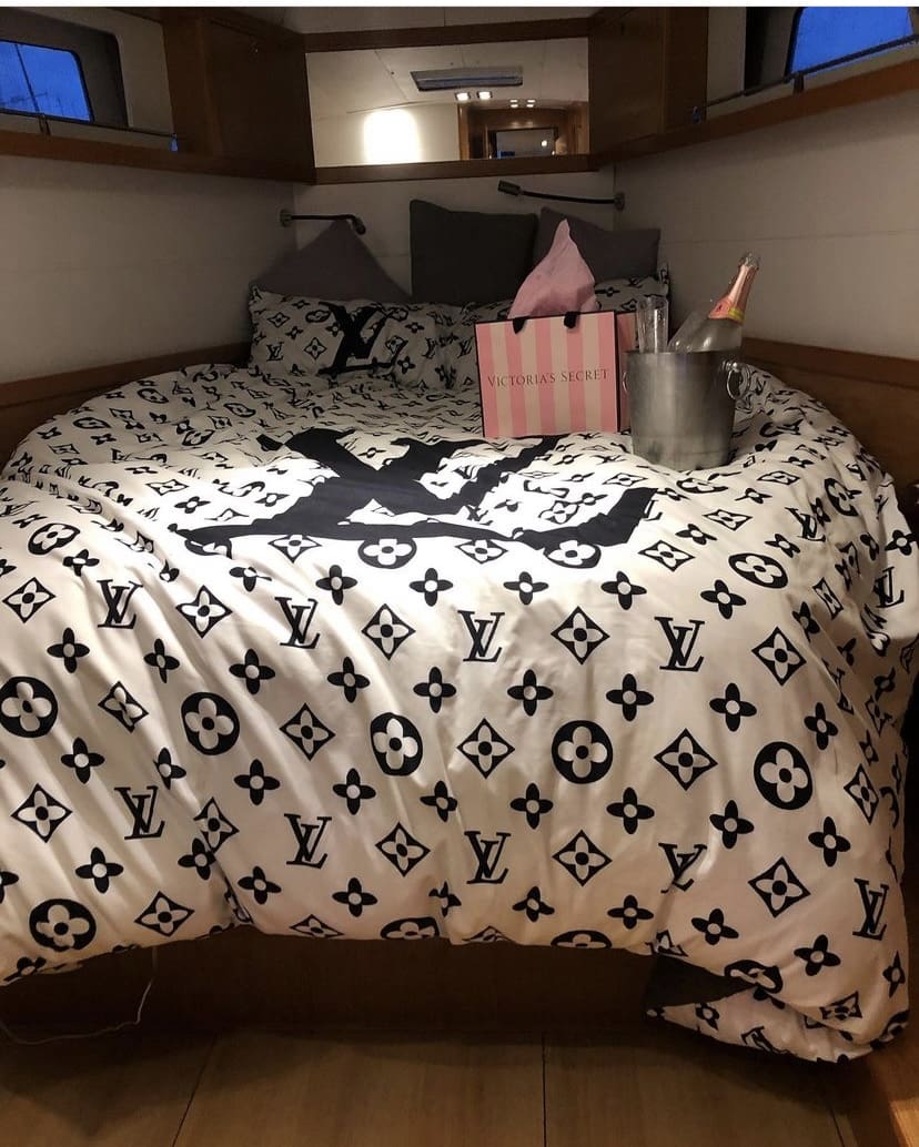 A bed with a black and white comforter on it