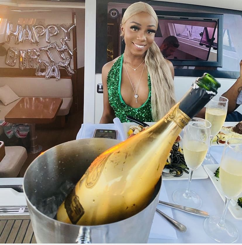 A woman sitting at a table with champagne.