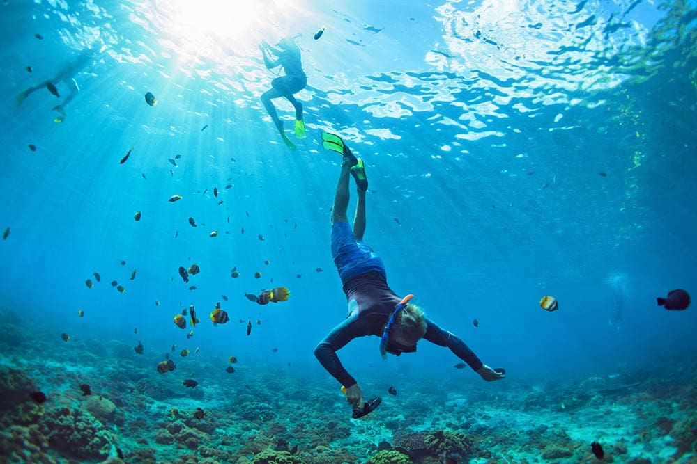 A person in the water with a mask on