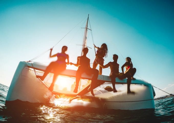 A group of people on a boat in the ocean.