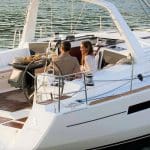 A couple of people are sitting on the deck of a boat