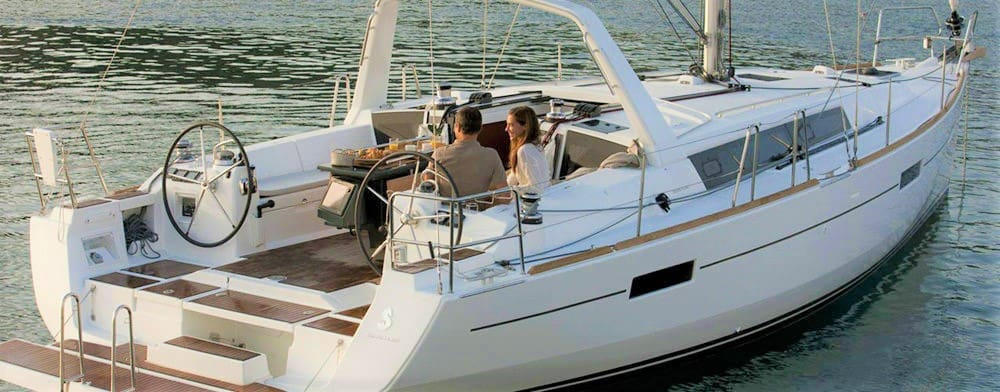 A couple of people on the deck of a boat.