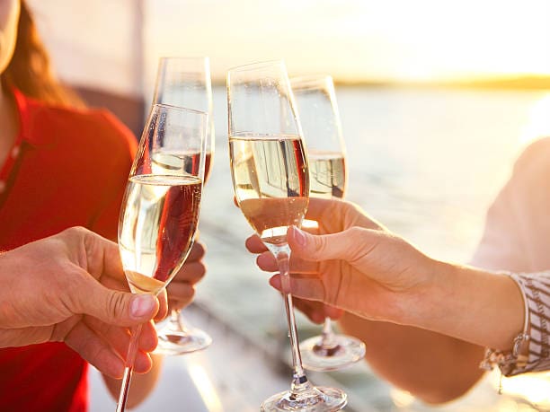 A group of people holding wine glasses in their hands.